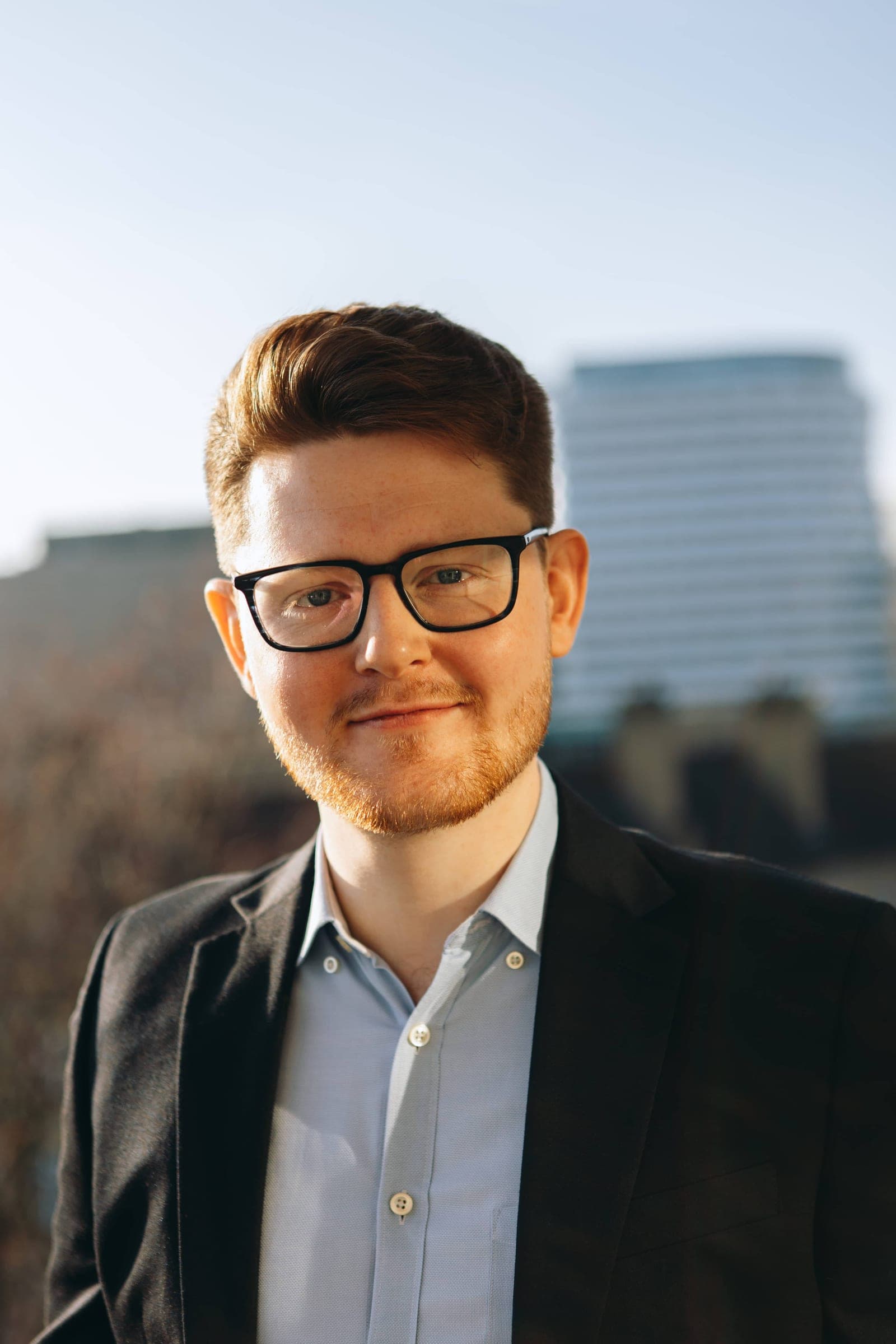 Angus Hally professional portrait on a balcony